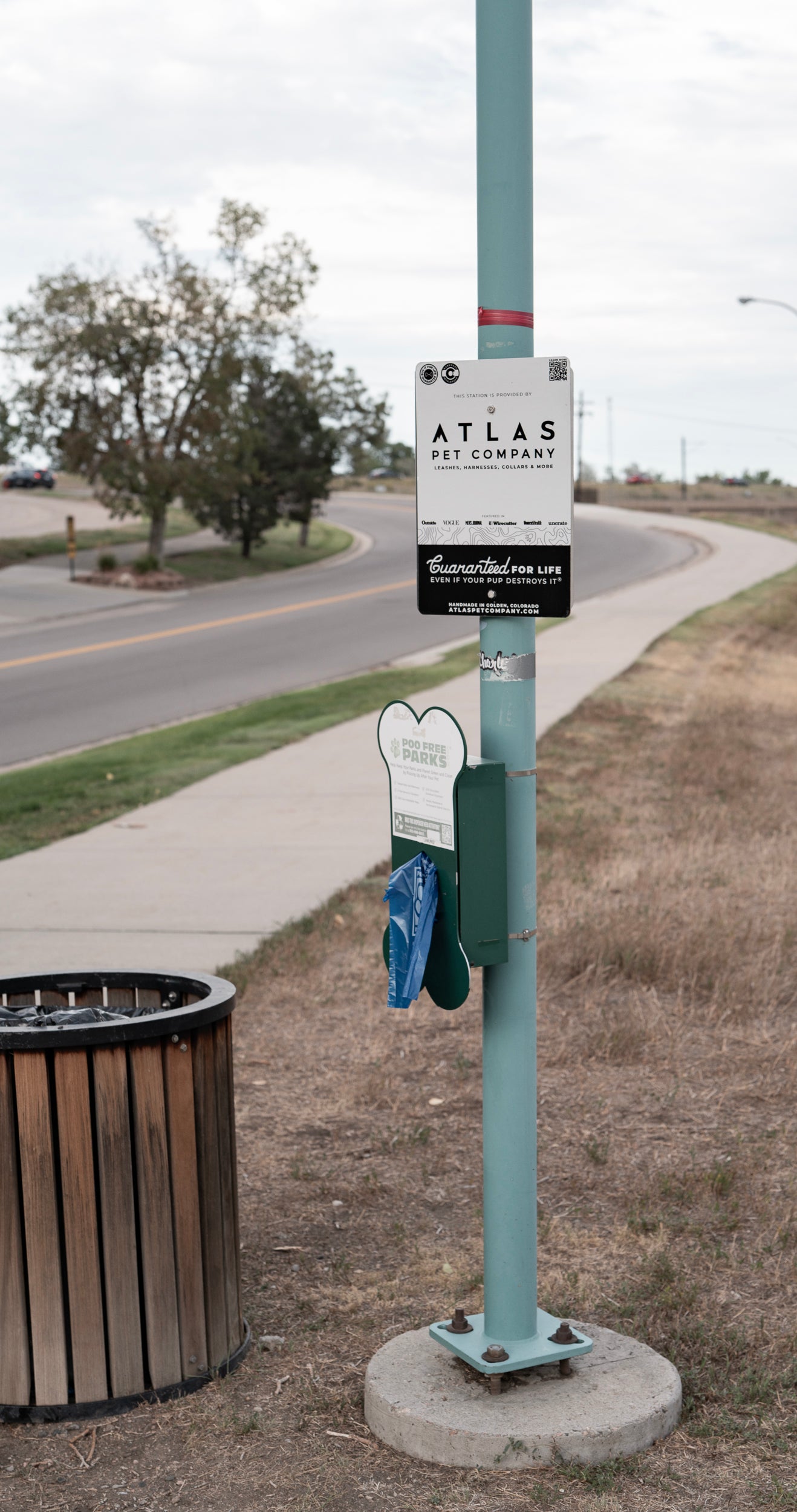 Atlas Pet Company poop-free parks poop bag dispenser at local park 