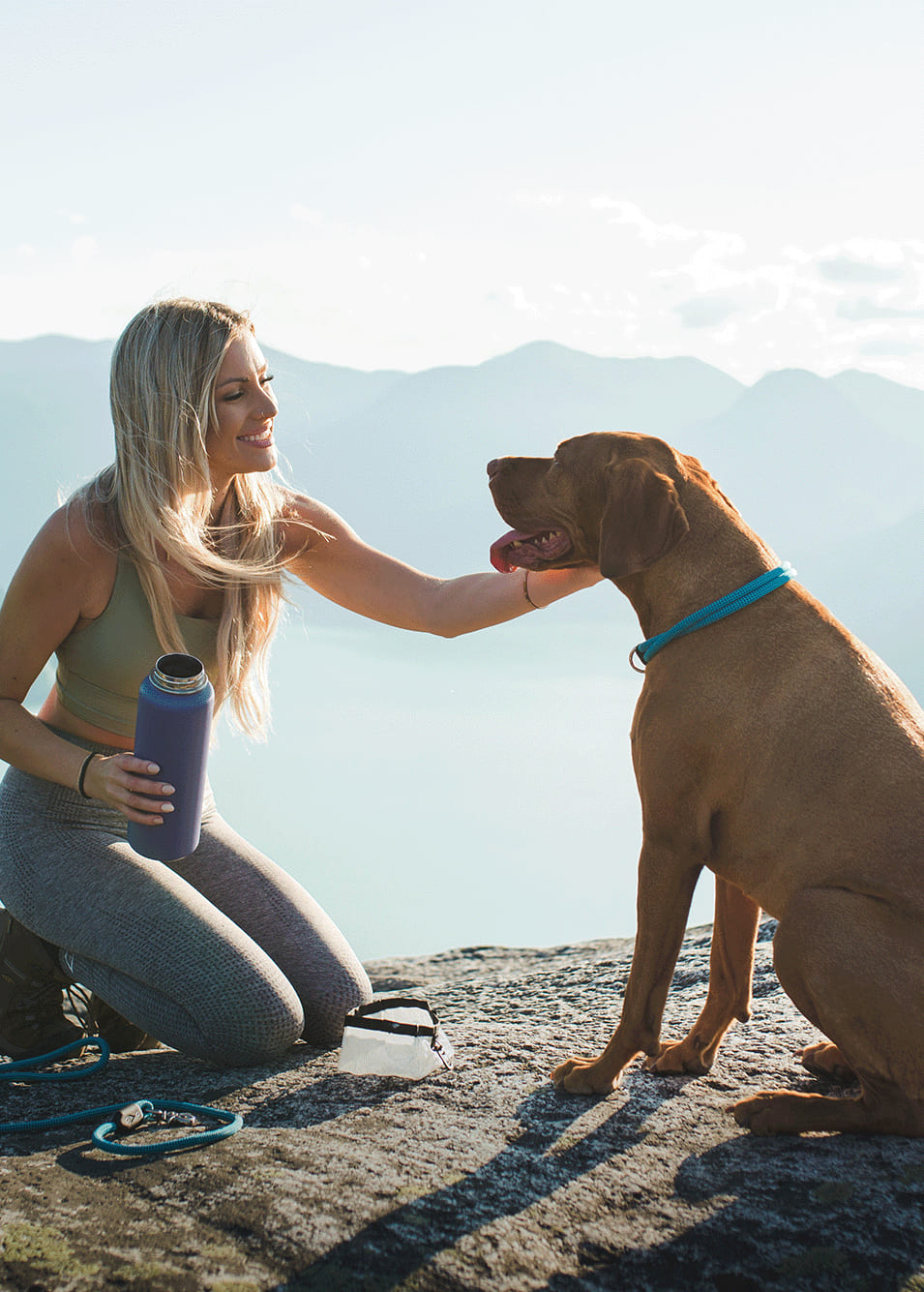Atlas Pet Company homepage hero with woman and dog hiking in the mountains